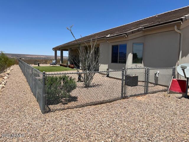 1067 N Jacobs Rd, Saint David, AZ 85630 - view of home's exterior with stucco siding and a gate