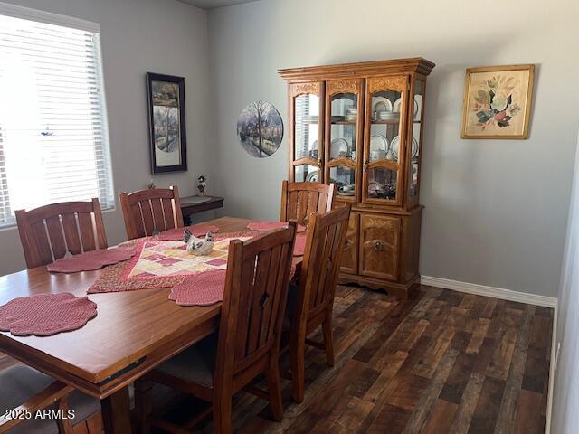1067 N Jacobs Rd, Saint David, AZ 85630 - dining area featuring dark wood-type flooring and baseboards