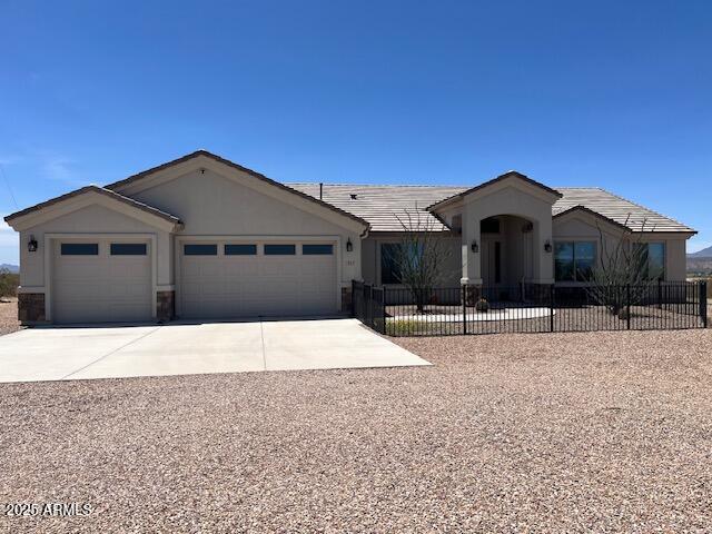 1067 N Jacobs Rd, Saint David, AZ 85630 - ranch-style home featuring an attached garage, driveway, and stucco siding