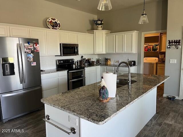 1067 N Jacobs Rd, Saint David, AZ 85630 - kitchen featuring stainless steel appliances, washing machine and clothes dryer, tasteful backsplash, white cabinets, and stone counters