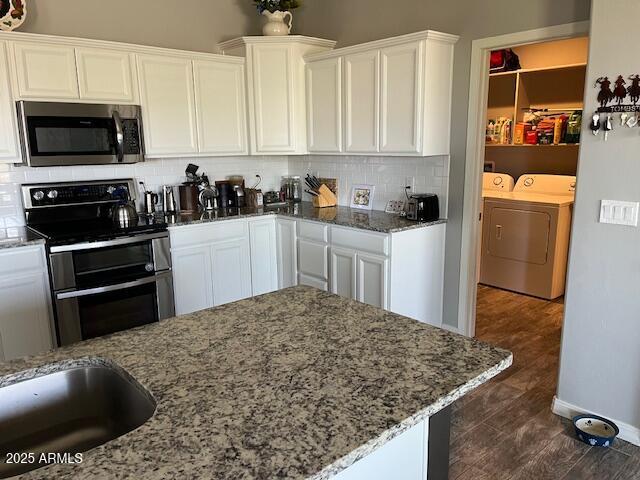 1067 N Jacobs Rd, Saint David, AZ 85630 - kitchen with appliances with stainless steel finishes, washing machine and dryer, stone countertops, and white cabinets