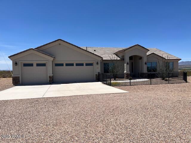1067 N Jacobs Rd, Saint David, AZ 85630 - ranch-style house featuring an attached garage, concrete driveway, and stucco siding