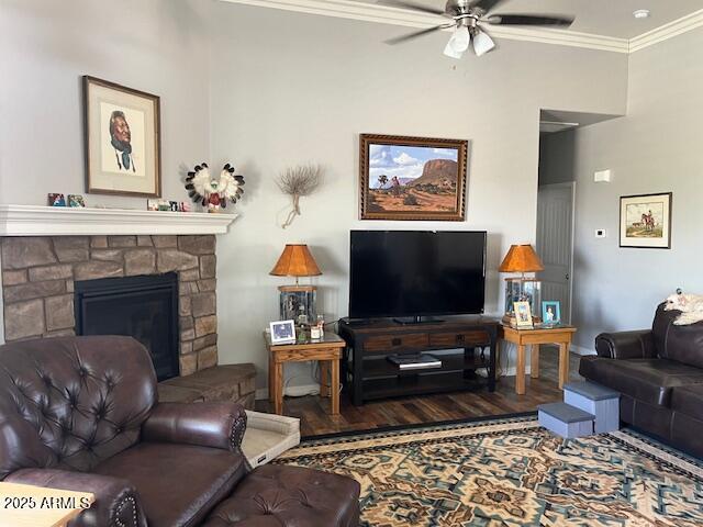 1067 N Jacobs Rd, Saint David, AZ 85630 - living area featuring a ceiling fan, ornamental molding, wood finished floors, and a stone fireplace