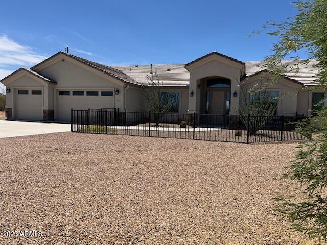 1067 N Jacobs Rd, Saint David, AZ 85630 - single story home featuring a garage, concrete driveway, stucco siding, and a tiled roof