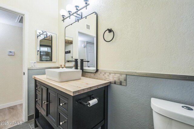 half bathroom featuring toilet and vanity