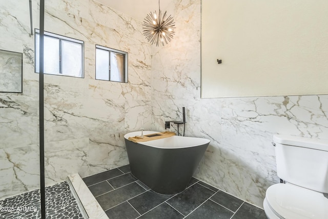 full bathroom featuring toilet, tile walls, a freestanding tub, and walk in shower