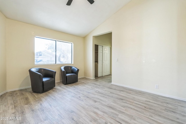 unfurnished room with ceiling fan, light wood-style floors, lofted ceiling, and baseboards