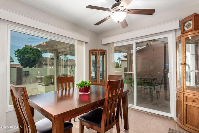 dining area with light tile patterned flooring and a ceiling fan