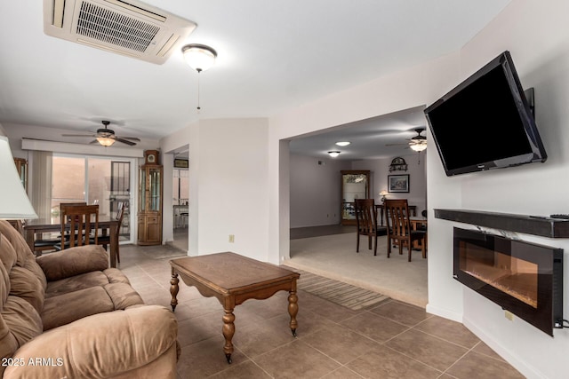 tiled living room featuring carpet, baseboards, ceiling fan, and visible vents