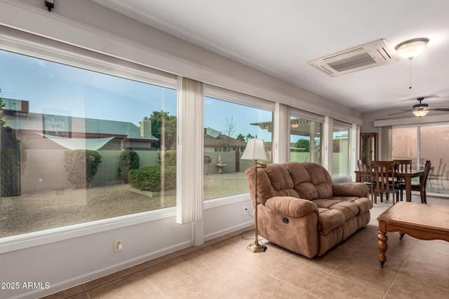 tiled living room with baseboards and ceiling fan