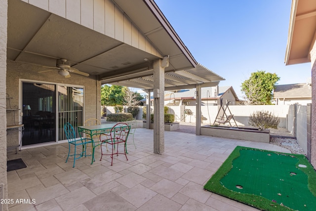 view of patio with a fenced backyard, outdoor dining area, and ceiling fan