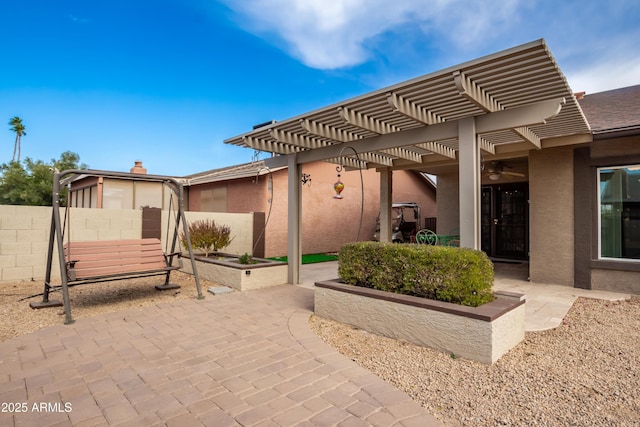 view of patio featuring a pergola and fence