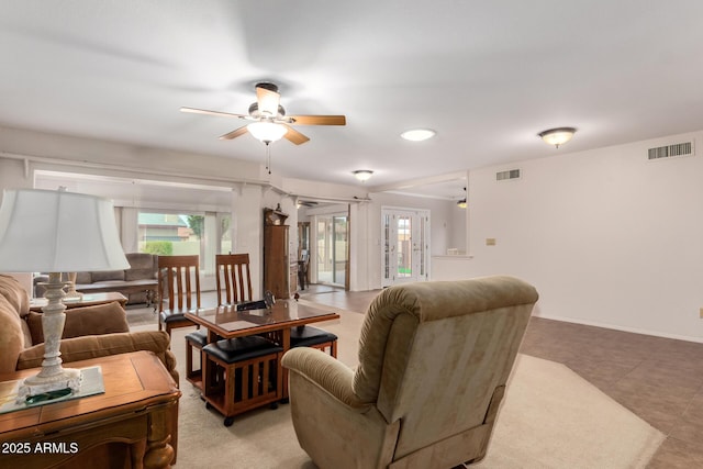 living area with ceiling fan, visible vents, and plenty of natural light