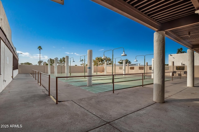 view of swimming pool featuring fence and shuffleboard
