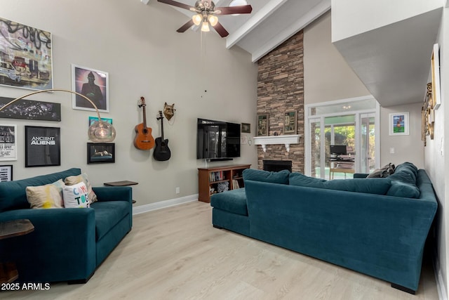 living room with high vaulted ceiling, light wood-type flooring, beamed ceiling, ceiling fan, and a fireplace