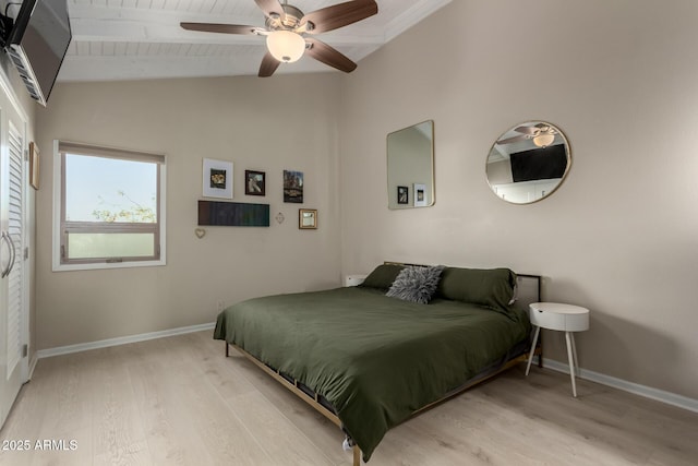 bedroom featuring ceiling fan, light hardwood / wood-style flooring, and vaulted ceiling