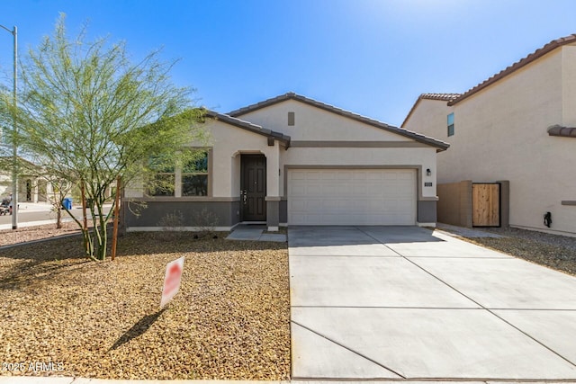 view of front of house with stucco siding, driveway, and an attached garage