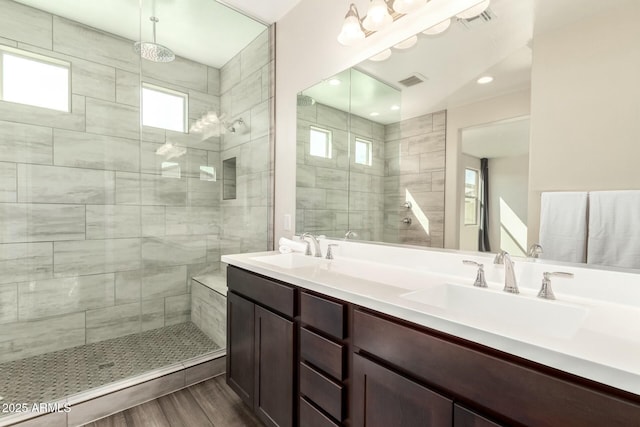 full bath featuring a sink, visible vents, and a shower stall