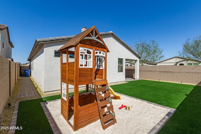 view of jungle gym with a fenced backyard and a lawn