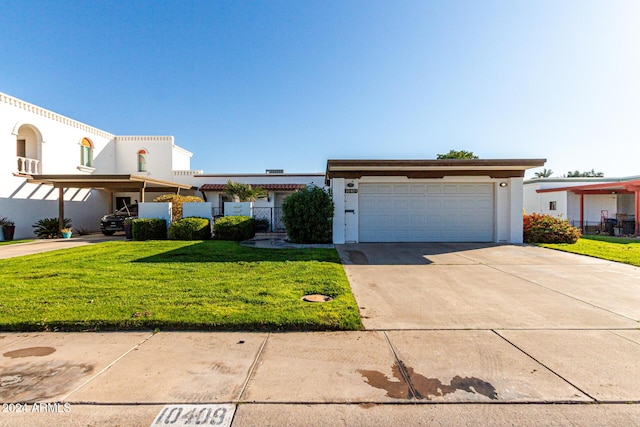 view of front of home with a front yard and a garage