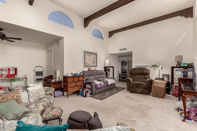 carpeted living room with beam ceiling, ceiling fan, and high vaulted ceiling