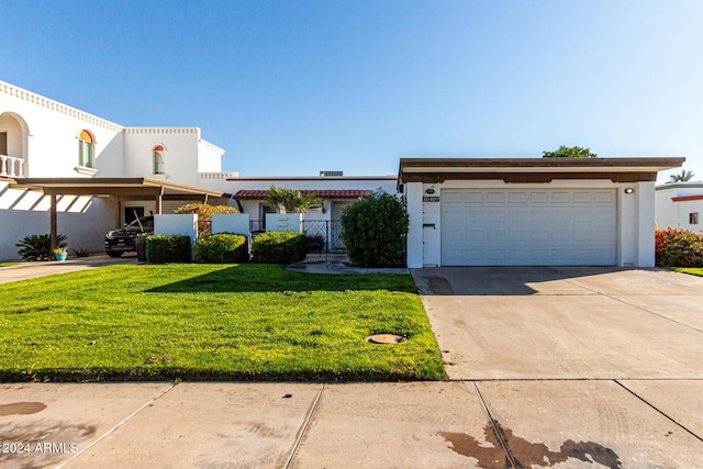 view of front of property featuring a front yard and a garage