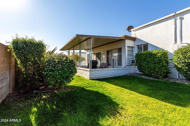 back of house featuring a lawn and cooling unit