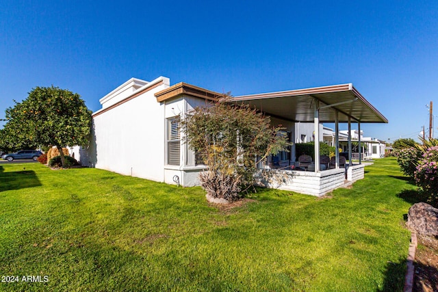 rear view of property with a yard