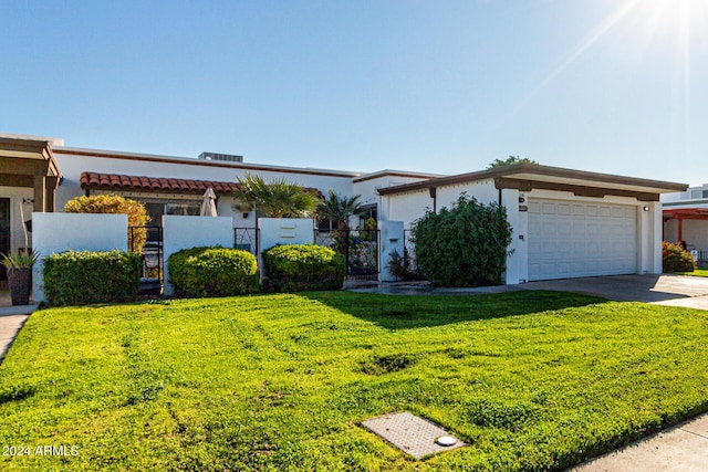 view of front of home featuring a garage and a front lawn