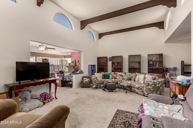 living room with ceiling fan, beamed ceiling, carpet floors, and high vaulted ceiling