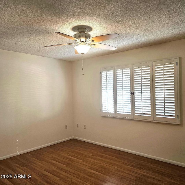 empty room featuring ceiling fan, dark hardwood / wood-style flooring, and a textured ceiling