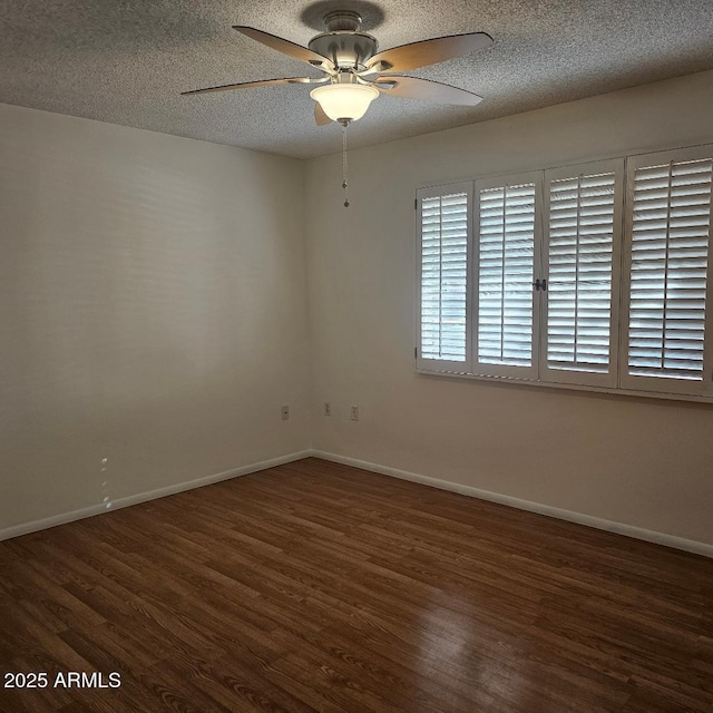 unfurnished room with ceiling fan, dark hardwood / wood-style flooring, and a textured ceiling