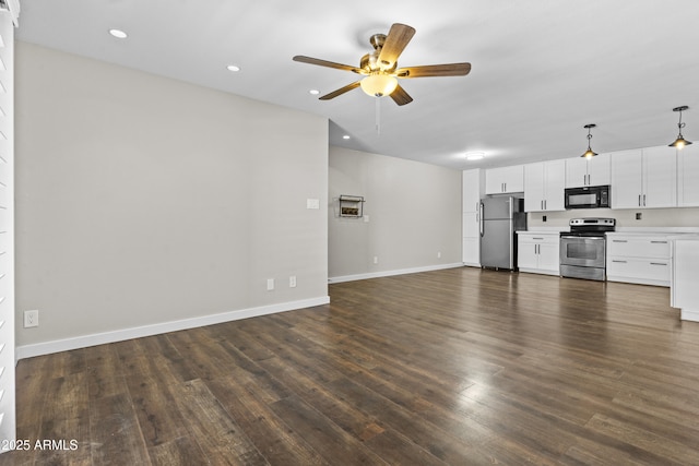unfurnished living room featuring a ceiling fan, dark wood finished floors, recessed lighting, and baseboards
