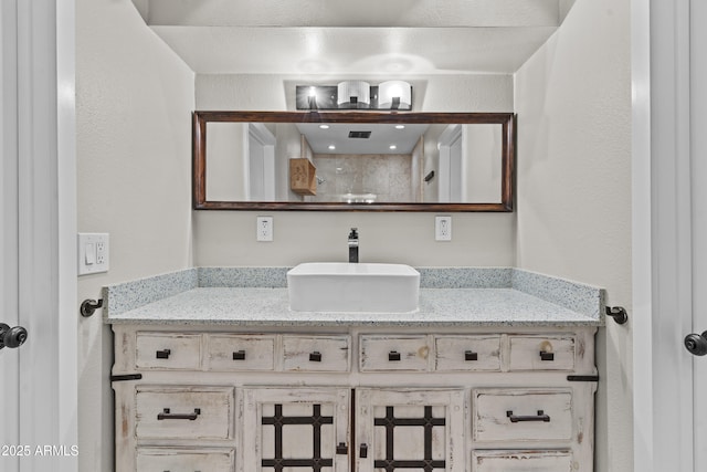 bathroom with vanity and a shower