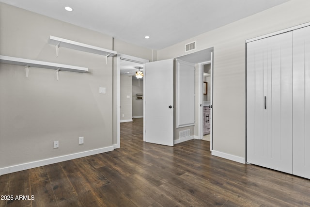 unfurnished bedroom featuring wood finished floors, baseboards, recessed lighting, and a closet