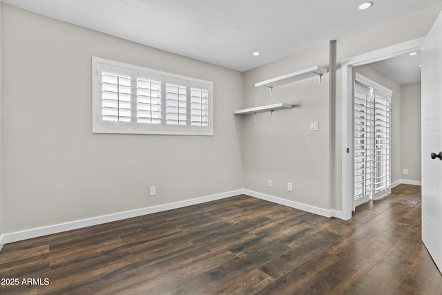 empty room featuring hardwood / wood-style floors, baseboards, and recessed lighting