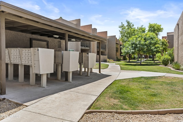 view of home's community featuring mail area and a lawn
