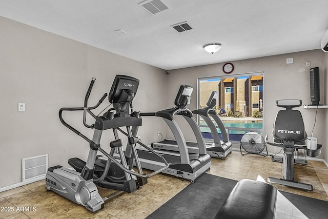 workout room featuring baseboards