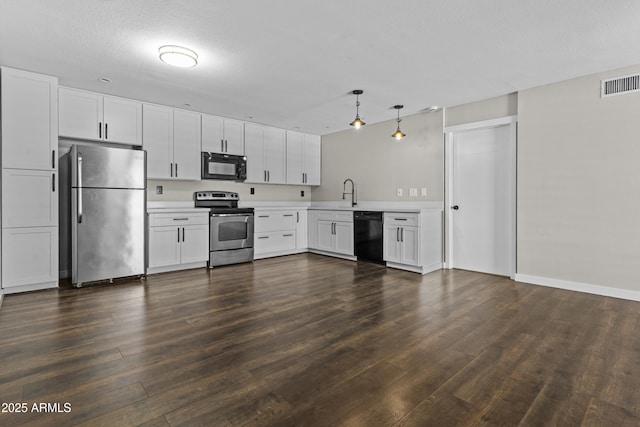 kitchen with black appliances, light countertops, dark wood-style flooring, white cabinets, and a sink