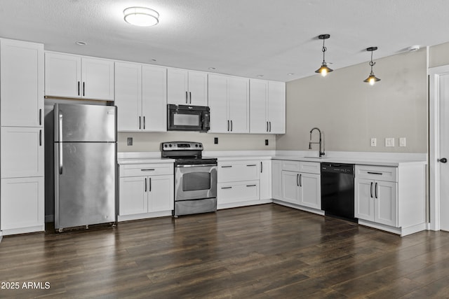 kitchen with black appliances, light countertops, a sink, dark wood finished floors, and a textured ceiling