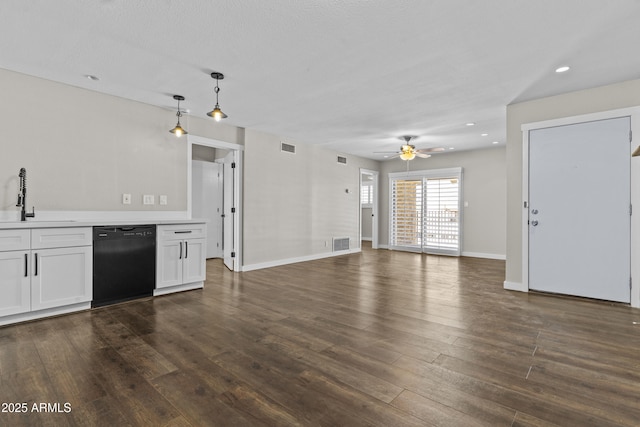 unfurnished living room with a sink, ceiling fan, dark wood-type flooring, baseboards, and recessed lighting