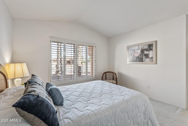 carpeted bedroom featuring lofted ceiling