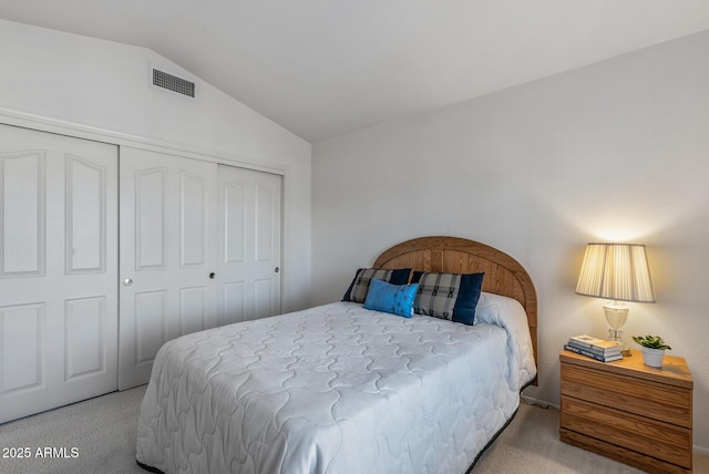 bedroom with lofted ceiling, carpet flooring, visible vents, and a closet