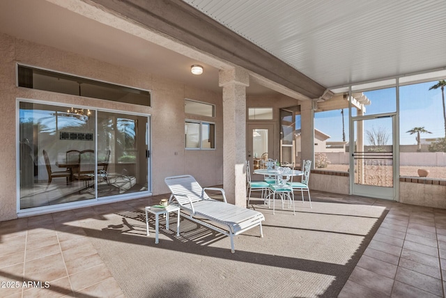 sunroom with outdoor dining area