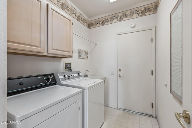 laundry room with cabinet space, washer and dryer, and a sink