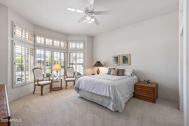 bedroom with baseboards, carpet, and multiple windows