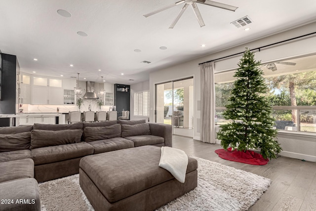 living room with light hardwood / wood-style flooring and ceiling fan