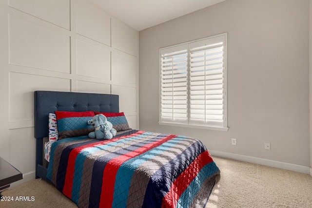 carpeted bedroom featuring multiple windows