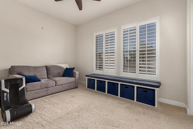 carpeted living room with ceiling fan