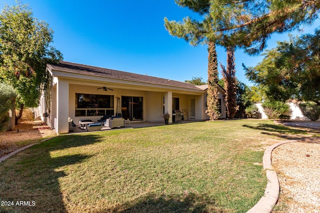 back of property featuring ceiling fan, a yard, a patio, and an outdoor hangout area